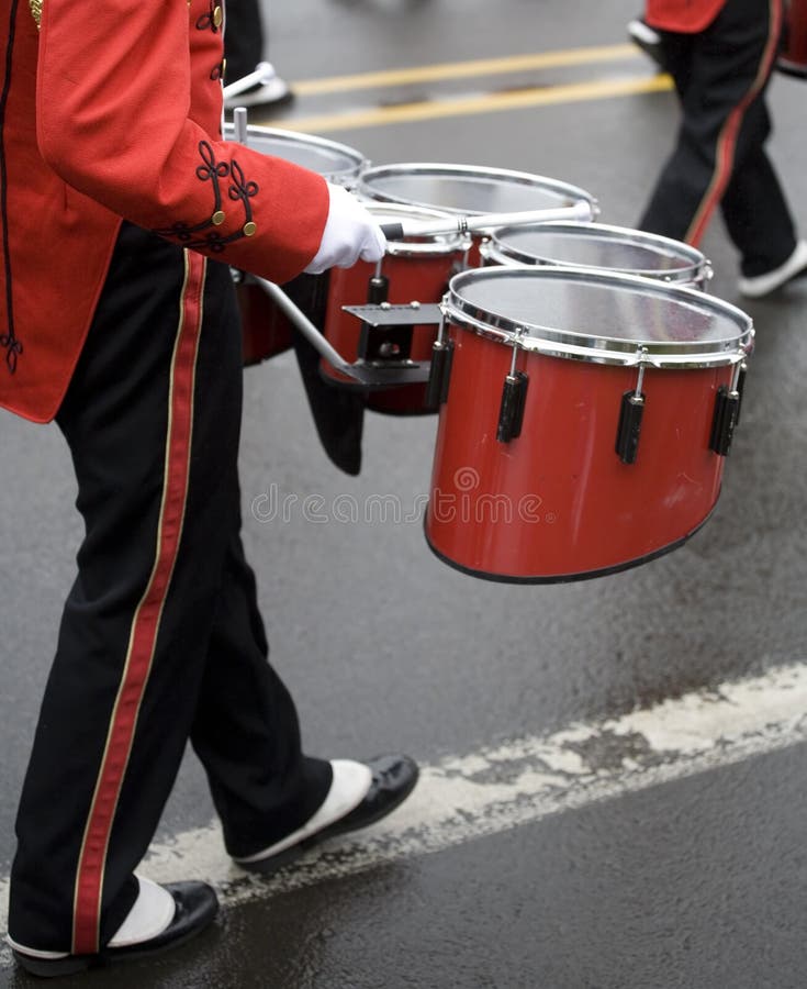 Drummer in a marching band on a foggy, wet day.
