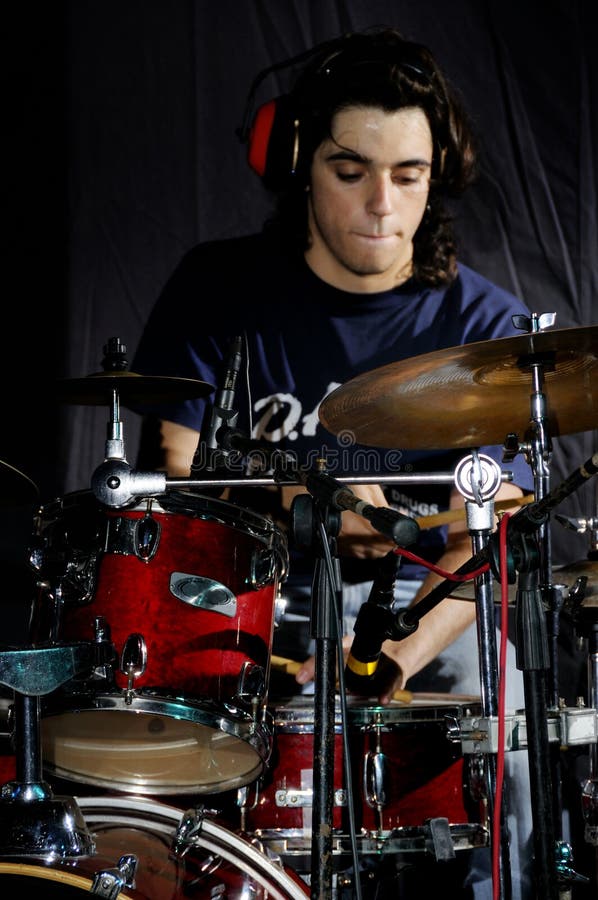 Portrait of young musician playing the drums. Portrait of young musician playing the drums