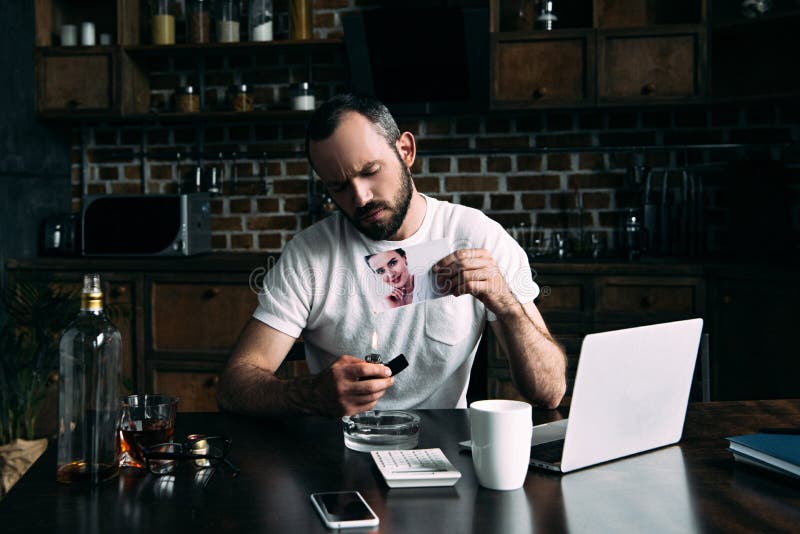 drunk depressed young man burning photo of ex-girlfriend royalty free stock photos drunk depressed young man burning photo of ex-girlfriend royalty free stock photos