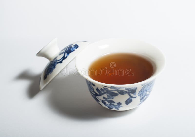 Dry Chinese Oolong Tea Leaf and Oolong Tea in Traditional Cup on White