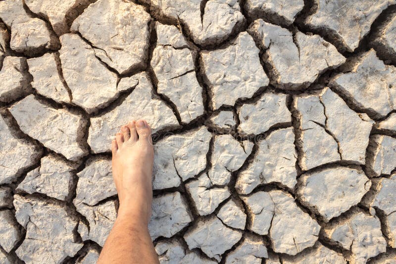 Dry Clay Land Foot the World Map Shows the Drought. Stock Photo Image
