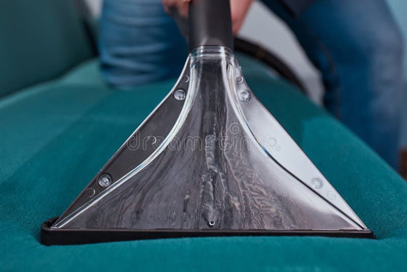 Dry Cleaning Worker Removing Dirt from Sofa Indoors. Stock Photo