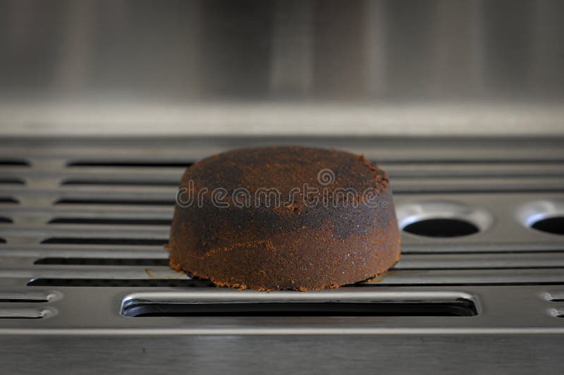Dry Coffee Puck Espresso Puck on the Tray of Espresso Machine Stock