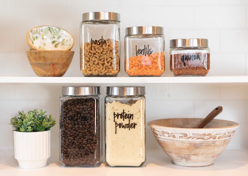 Food Ingredients In Glass Jars On A Kitchen Counter Top. Stock