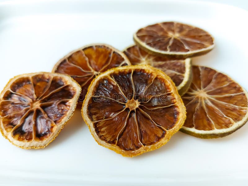 Dry lemon wedges on white background royalty free stock photo