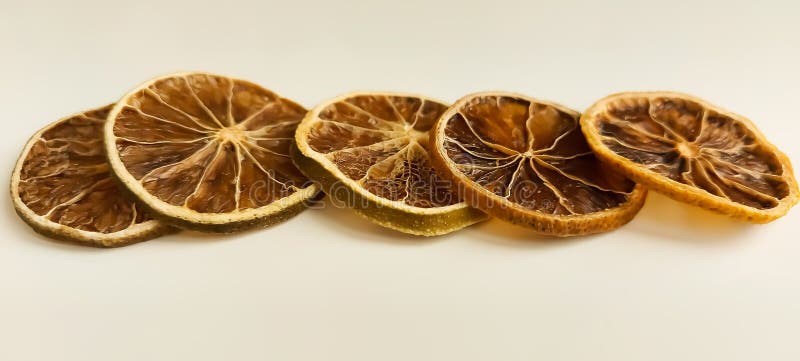 Dry lemon wedges on white background stock images