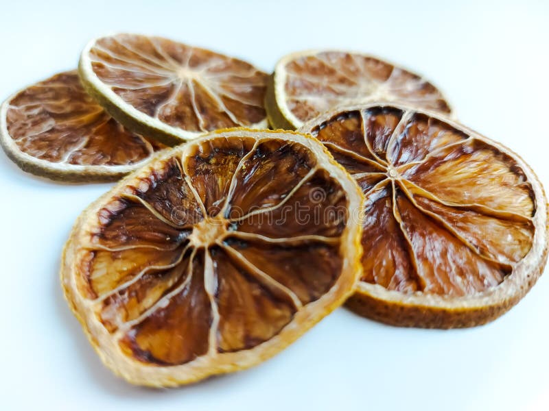 Dry lemon wedges on white background stock images