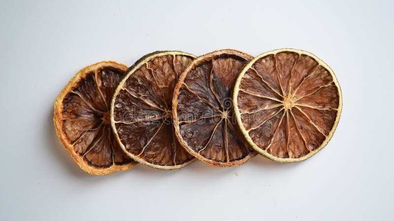 Dry lemon wedges on white background royalty free stock photography