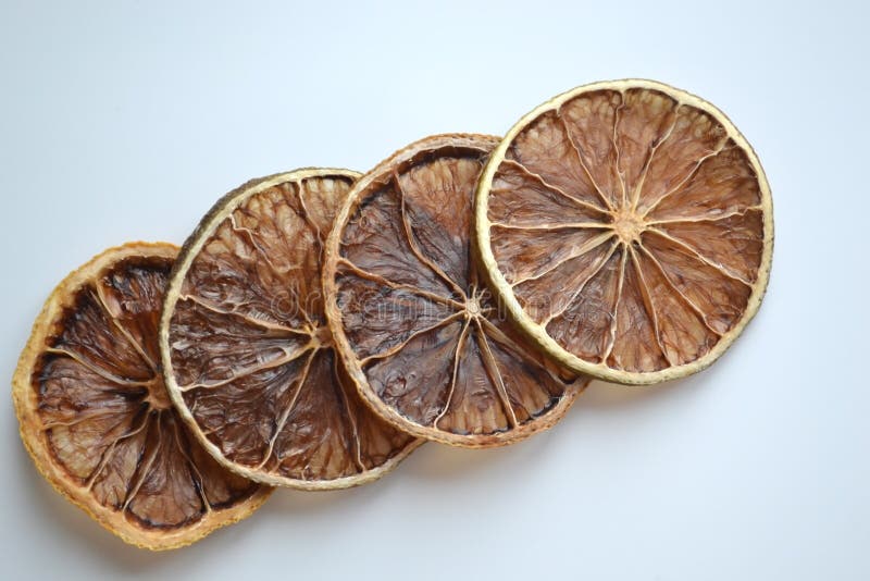 Dry lemon wedges on white background stock photos