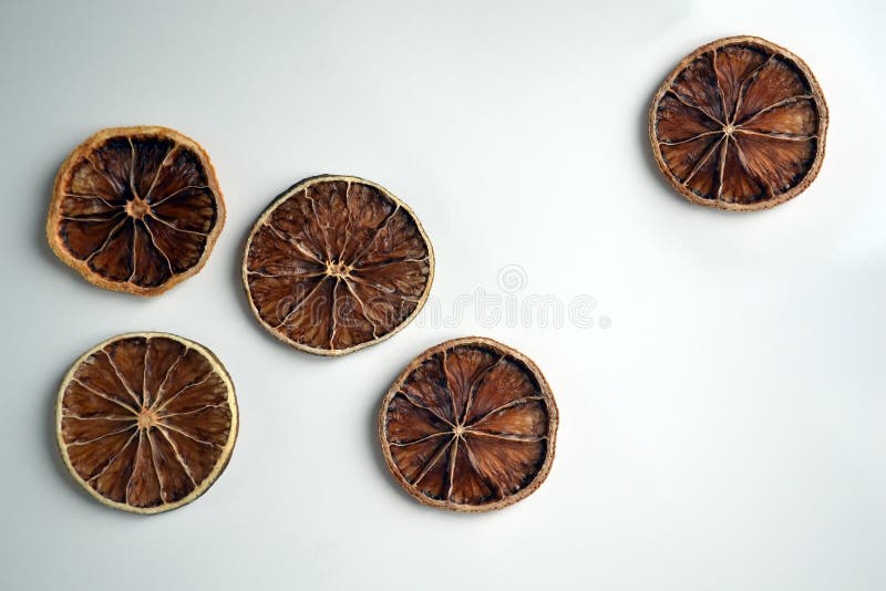 Dry lemon wedges on white background royalty free stock photo