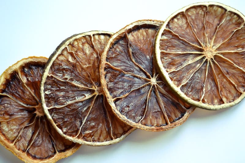 Dry lemon wedges on white background royalty free stock photography