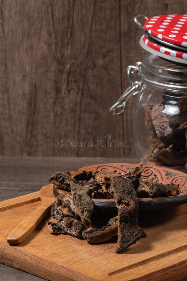 Jar with Mushrooms, Dry Mushrooms on an Old Oak Board Stock Image