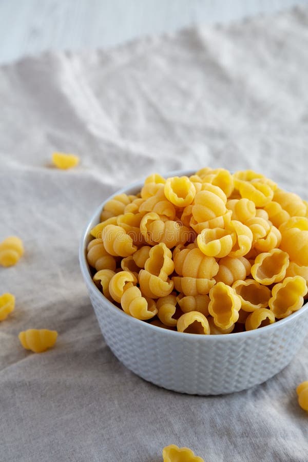 Dry Organic Gnocchi Pasta in a Bowl, Side View. Space for Text Stock