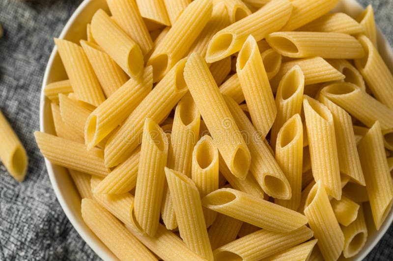 Dry Organic Penne Pasta stock image. Image of cooking 272195147