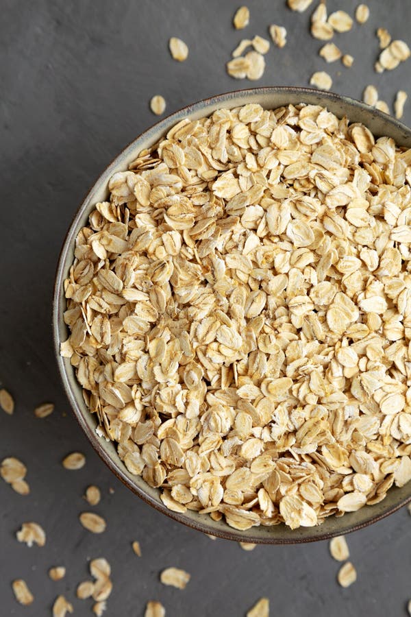Dry Organic Rolled Oats in a Bowl on a Gray Surface, Top View. Flat Lay ...