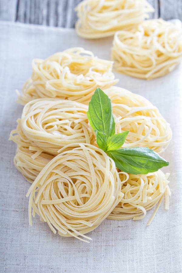 Dry pasta with fresh basil stock image. Image of culture 49479483