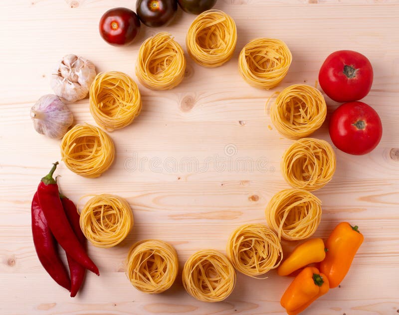Dry Pasta Rolls and Ingredients for Making a Tomato Sauce Stock Image