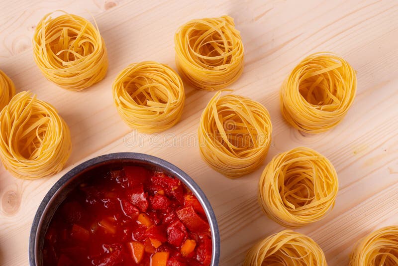 Dry Pasta Rolls and Ingredients for Making a Tomato Sauce Stock Image