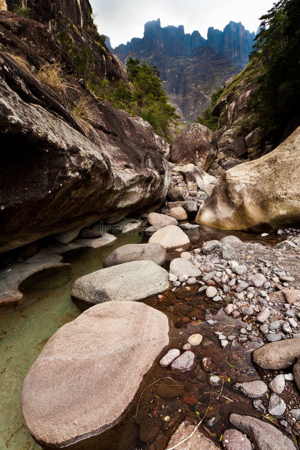 Dry riverbed with mountains in the background