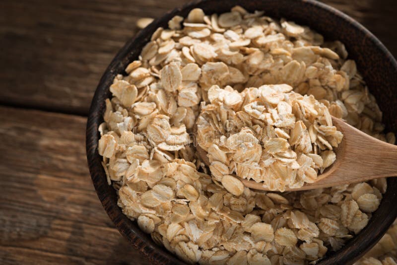 Dry Rolled Oat Flakes Oatmeal on Old Wooden Stock Photo - Image of ...