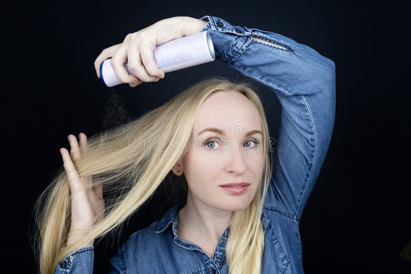 Dry Shampoo. Blonde Girl Sprays Shampoo on Her Hair. the Problem of ...