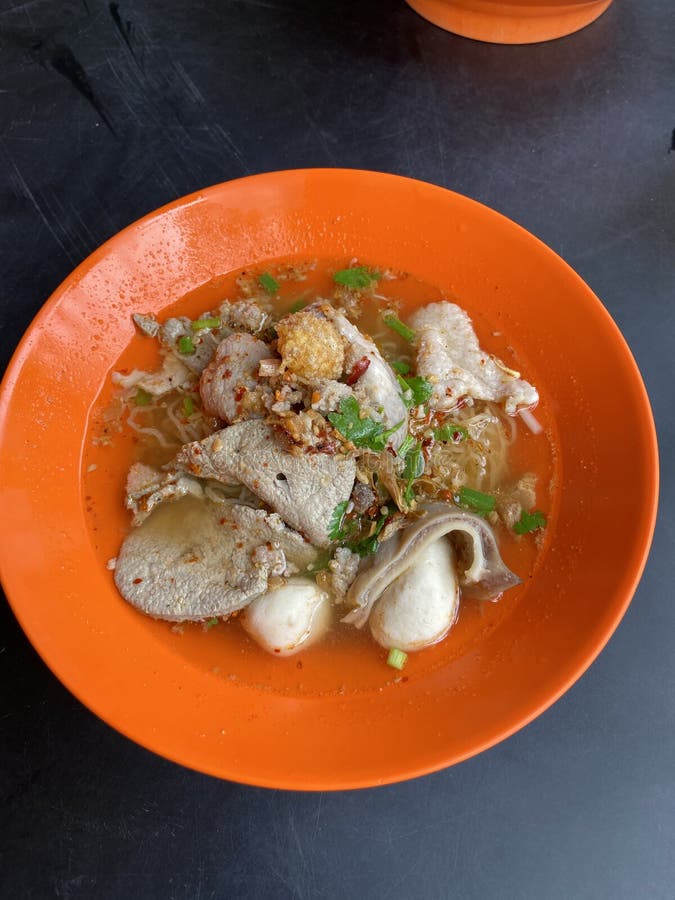 Close up dry tomyum noodle on wooden table