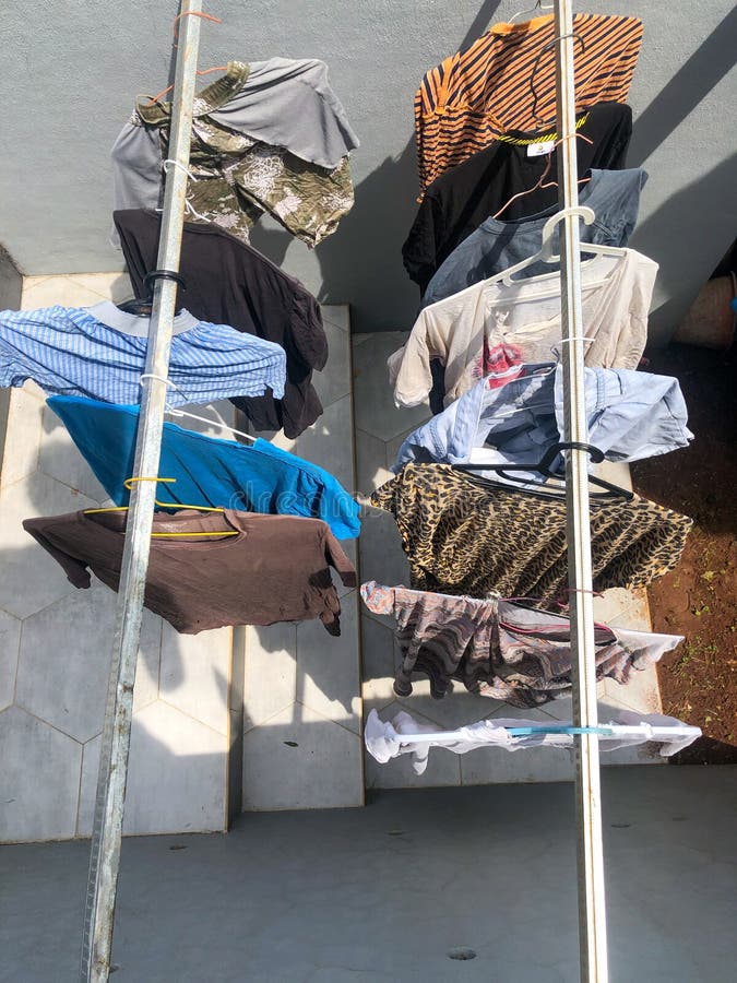 Drying clothes under sun stock photo. Image of bright 263971798