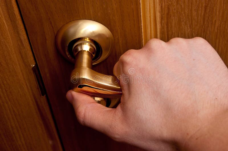 Man hand opening wooden door. Horizontal shot. Man hand opening wooden door. Horizontal shot