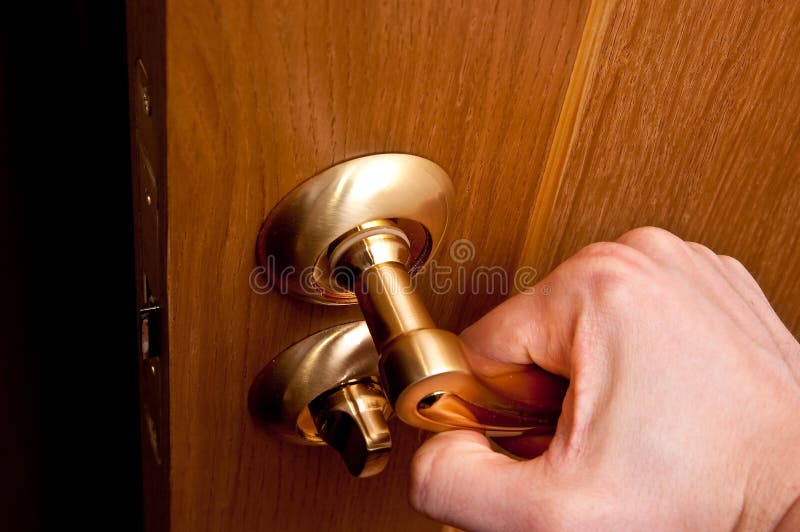 Man hand opening door leading into dark room. Man hand opening door leading into dark room