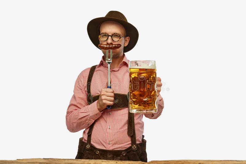 Funny, weird man wearing traditional fest Bavarian or German outfit with big beer glass and fried sausage celebrating Oktoberfest. Alcohol, traditions, holidays, taste concept. Copy space for ad. Funny, weird man wearing traditional fest Bavarian or German outfit with big beer glass and fried sausage celebrating Oktoberfest. Alcohol, traditions, holidays, taste concept. Copy space for ad