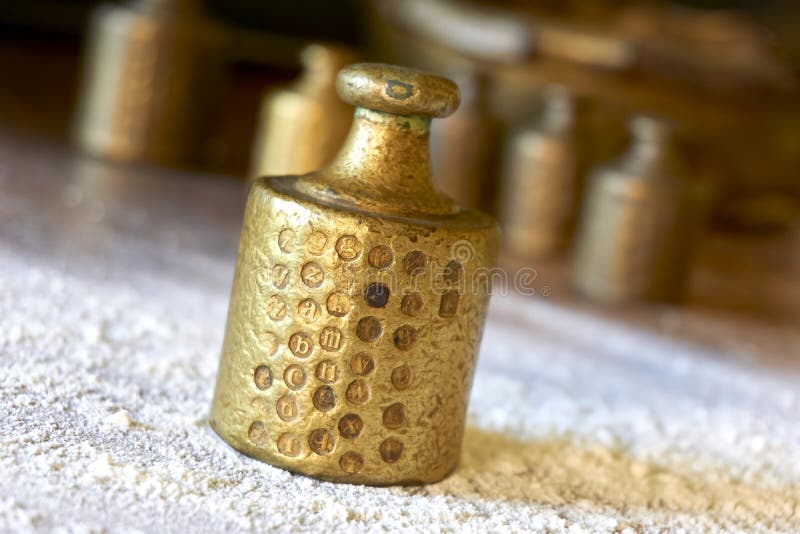 Old copper brass scale weights on a table