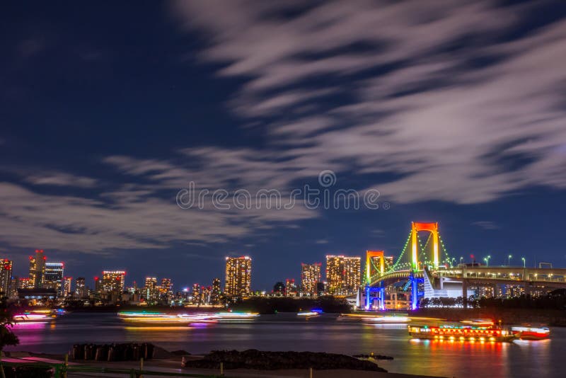 Odaiba, Tokyo, Beautiful and colorful rainbow bridge and Tokyo city night background image, cloudy in motion and left copy space f stock photos Odaiba, Tokyo, Beautiful and colorful rainbow bridge and Tokyo city night background image, cloudy in motion and left copy space f stock photos
