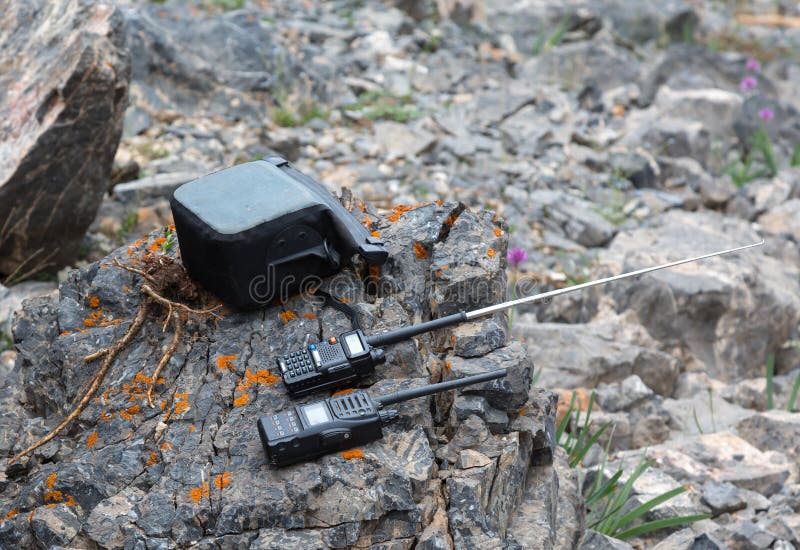 Communication Device for Connection in Wild Remote Area Expeditions Located on Colorful Rock Stone. Communication Device for Connection in Wild Remote Area Expeditions Located on Colorful Rock Stone