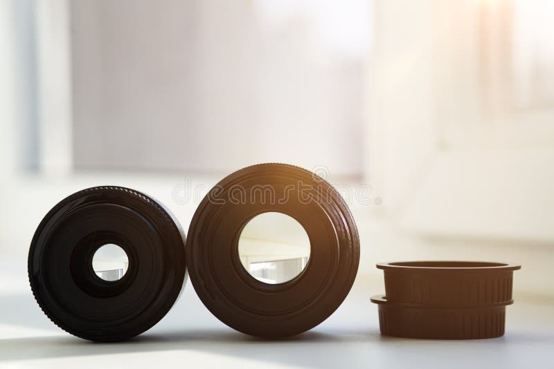 Two lenses with different focal lengths close-up on a light background. Sunlight shines through. Selection of lenses. High quality photo. Two lenses with different focal lengths close-up on a light background. Sunlight shines through. Selection of lenses. High quality photo