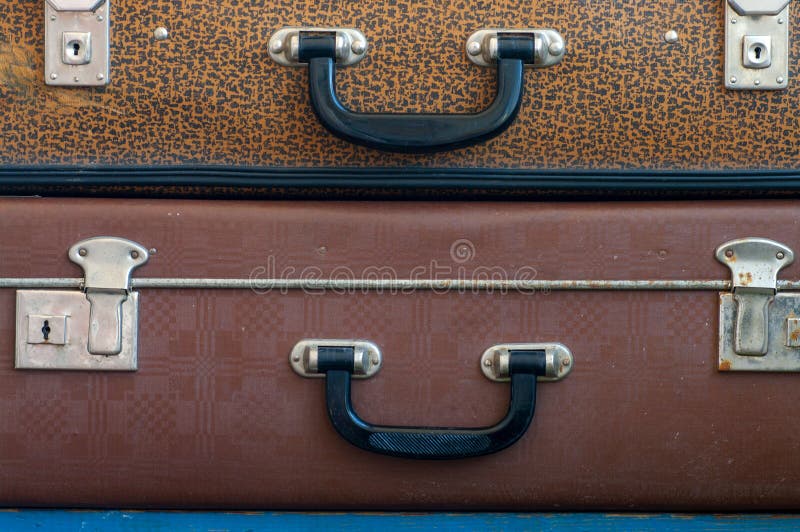 Two old closed suitcases on top of each other. Close up. Travel background. Two old closed suitcases on top of each other. Close up. Travel background.