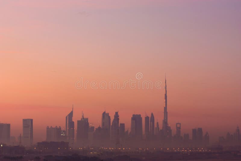 The sunrise view of the modern buildings of Dubai including the world's tallest building Burj Khalifa and Emirates Towers. The sunrise view of the modern buildings of Dubai including the world's tallest building Burj Khalifa and Emirates Towers