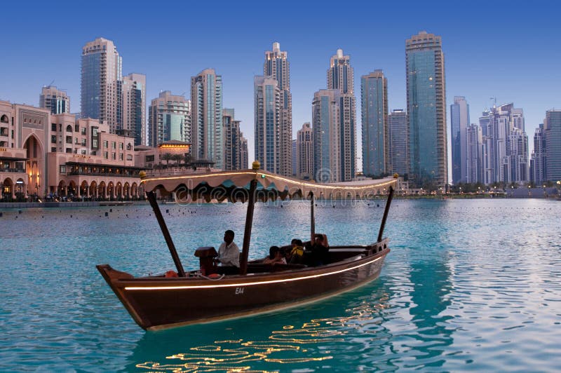 DUBAI, UAE - JUNE 1: Driving by wooden boats near dancing fountains stock photos DUBAI, UAE - JUNE 1: Driving by wooden boats near dancing fountains stock photos