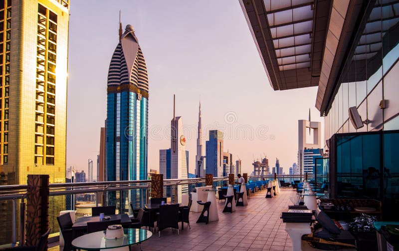 Dubai, United Arab Emirates - April 3, 2018: Modern skyscrapers of downtown Dubai from a rooftop at sunset, modern architecture of