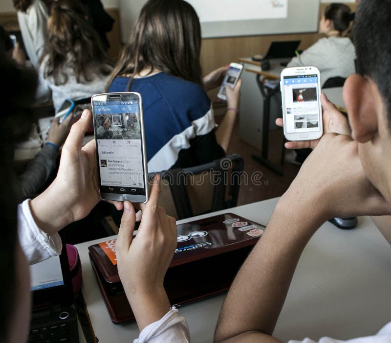 Young students using their mobile phones during their school daily classes in Majorca, Spain. Young students using their mobile phones during their school daily classes in Majorca, Spain