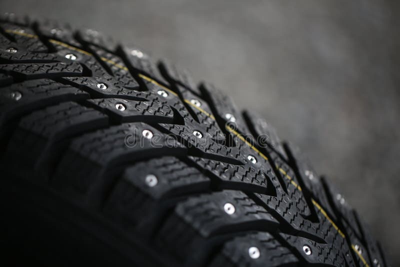 Studded tire on a gray background. Studded tire on a gray background