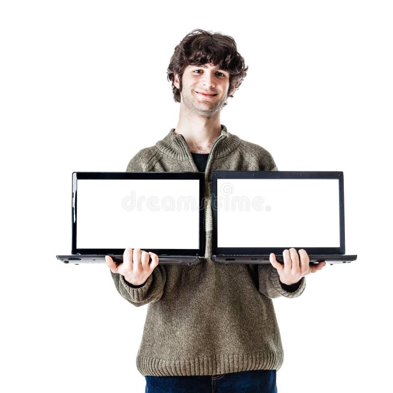An handsome guy, maybe a student, in casual clothing showing two laptops with blank monitors. An handsome guy, maybe a student, in casual clothing showing two laptops with blank monitors