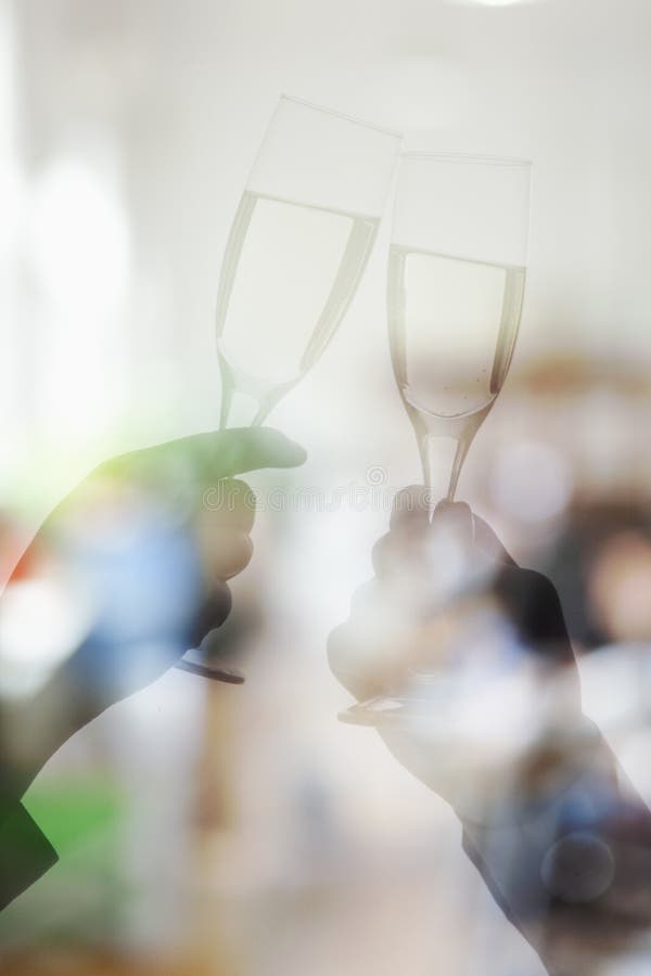 Double exposure of couple toasting with champagne flutes, arms only. Double exposure of couple toasting with champagne flutes, arms only