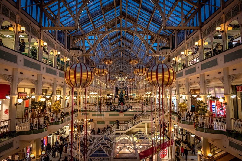 DUBLIN, IRELAND, DECEMBER 24, 2018: People shopping at Stephens Green Shopping Centre, decorated with Christmas lights, balls and