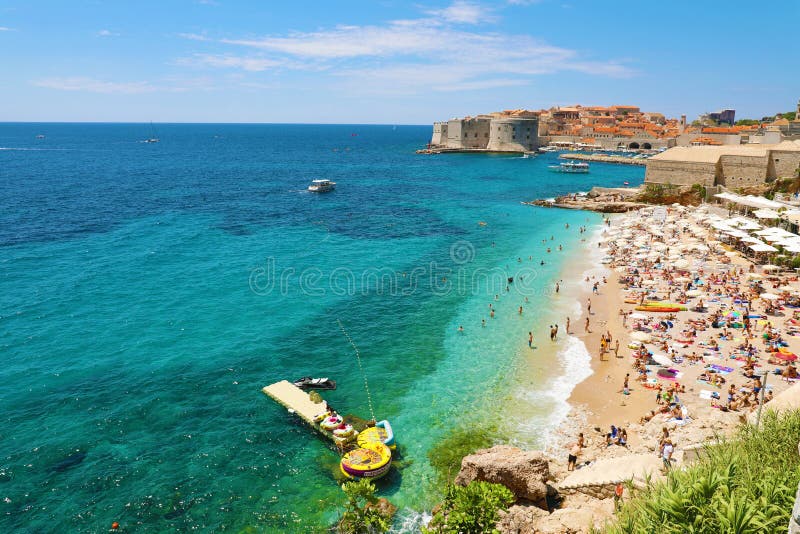 DUBROVNIK KROATIEN - JULI 12, 2019: Flyg- sikt av Dubrovnik den gamla staden och Banje stranden, Adriatiskt hav arkivfoton DUBROVNIK KROATIEN - JULI 12, 2019: Flyg- sikt av Dubrovnik den gamla staden och Banje stranden, Adriatiskt hav arkivfoton