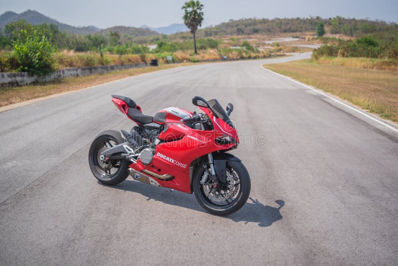 Phetchaburi, Thailand - April 14, 2016: Beautiful red Ducati 899 motorbike, photographed outdoor on a cloudy day. Red super bike Ducati 899, it is a V-twin Desmodromic valve actuated engine sport bike by Ducati Motor Holding. Phetchaburi, Thailand - April 14, 2016: Beautiful red Ducati 899 motorbike, photographed outdoor on a cloudy day. Red super bike Ducati 899, it is a V-twin Desmodromic valve actuated engine sport bike by Ducati Motor Holding.