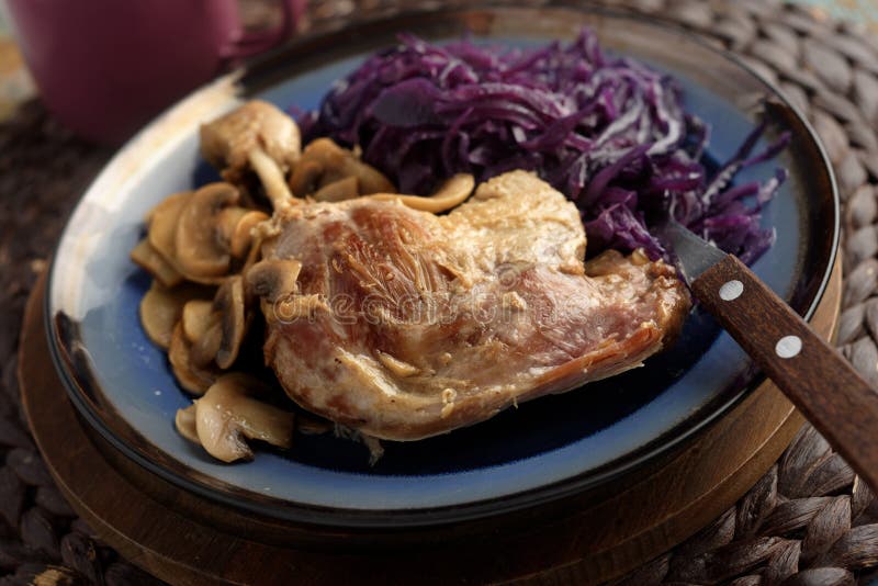 Duck leg with mushrooms and red cabbage