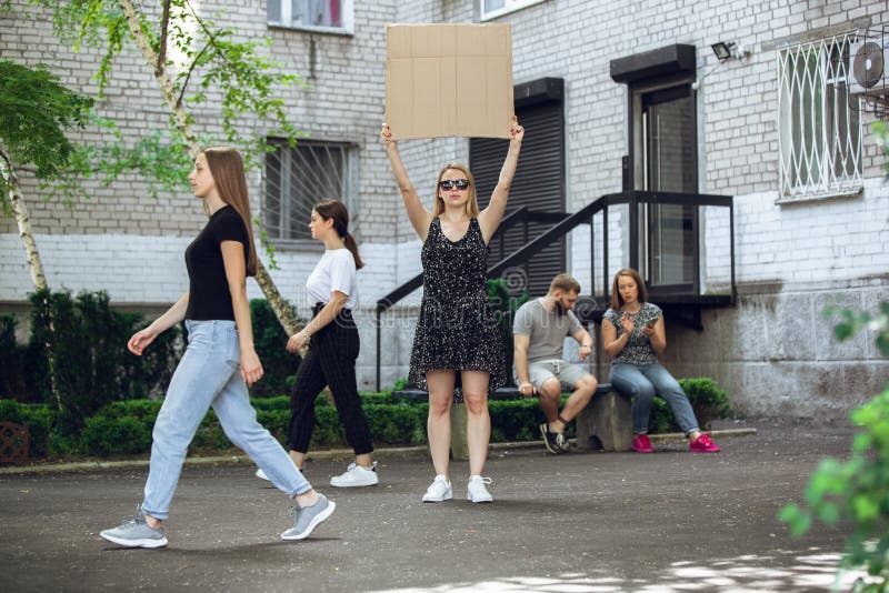 Dude with sign - woman stands protesting things that annoy her