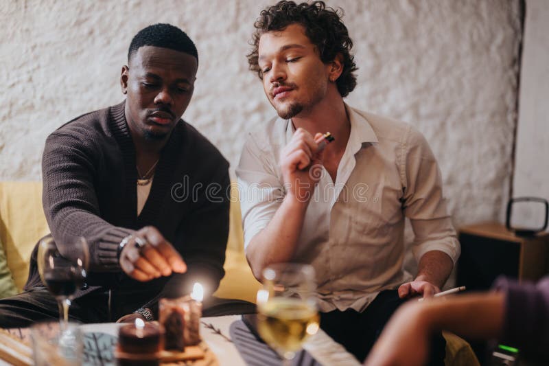 Due amici accendono insieme candele in un bar accogliente fotografia stock libera da diritti