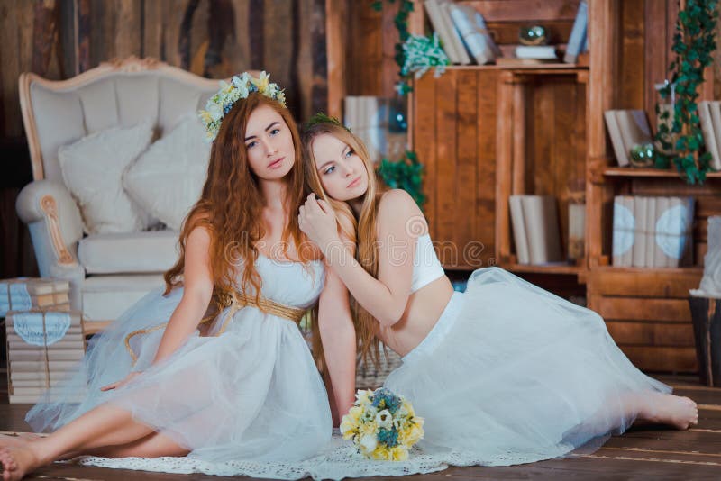 Due belle spose sensuali che si siedono nell'annata fotografie stock Due belle spose sensuali che si siedono nell'annata fotografie stock