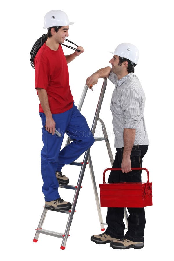 Due elettricisti che hanno a chiacchierata immagine stock libera da diritti Due elettricisti che hanno a chiacchierata immagine stock libera da diritti
